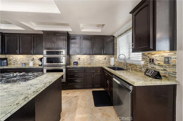a kitchen with a stove sink and cabinets