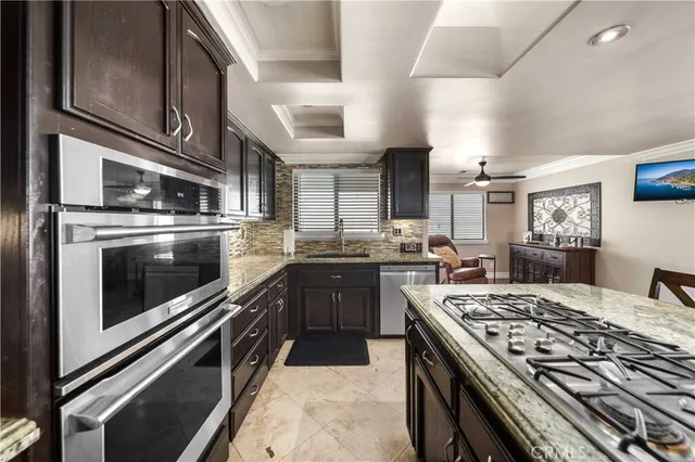 a kitchen with stainless steel appliances granite countertop a stove and a sink