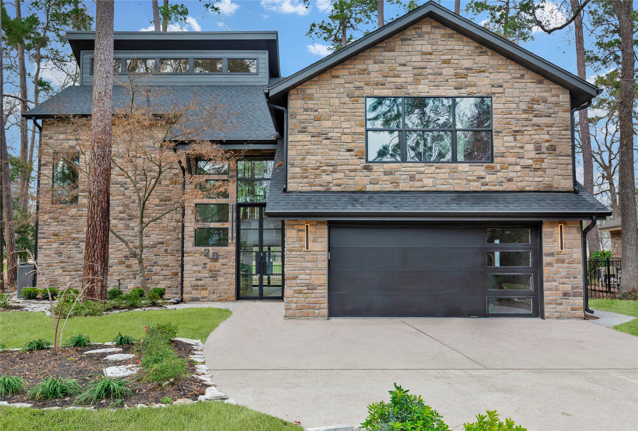 20 Buttonbush Court The Woodlands, TX 77380 - Photo 1 of 43 a front view of a house with garden