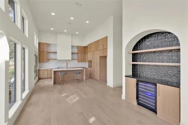 a kitchen with a sink a refrigerator and window