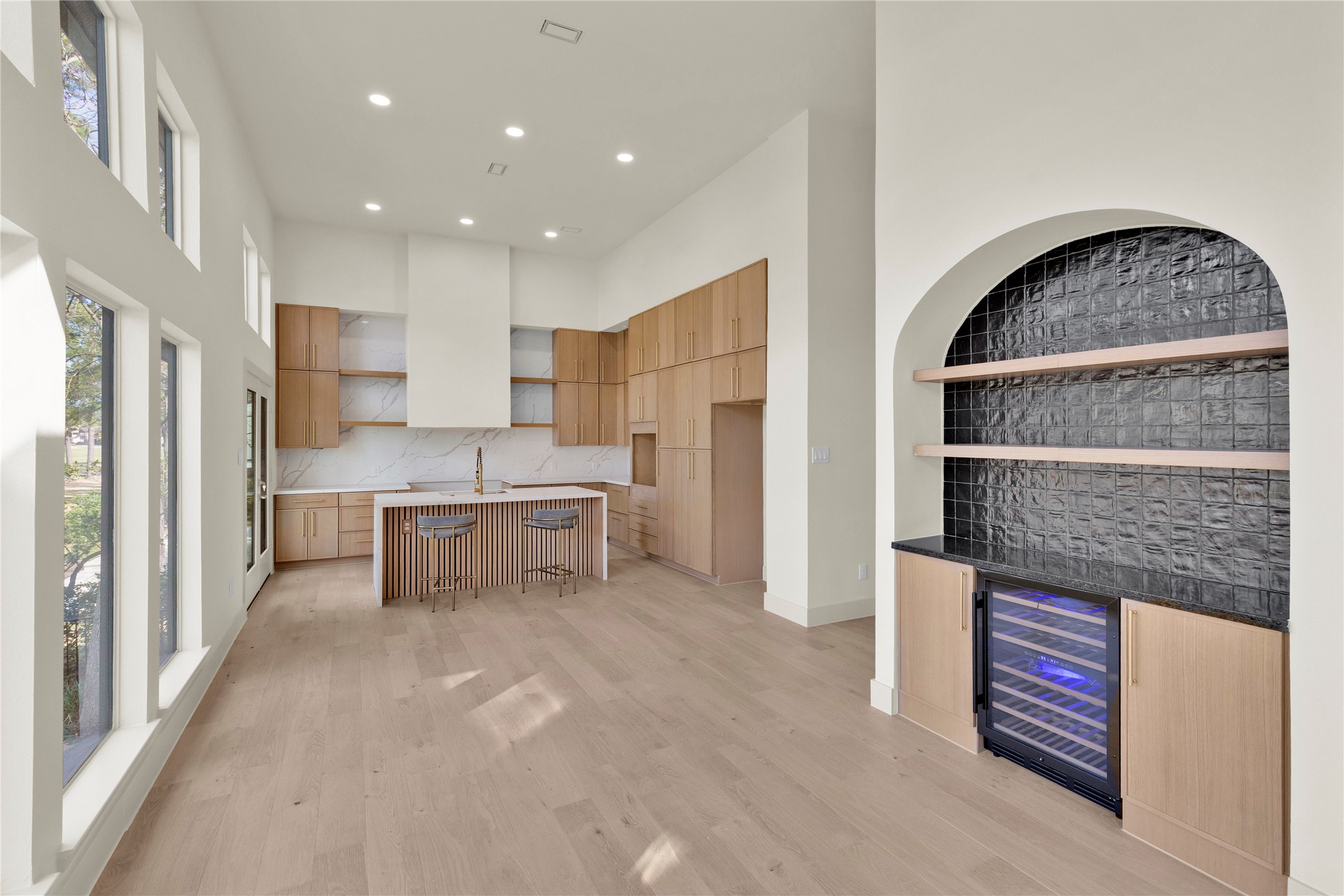 20 Buttonbush Court The Woodlands, TX 77380 - Photo 12 of 43 a view of cabinets with kitchen island stainless steel appliances refrigerator sink and cabinets
