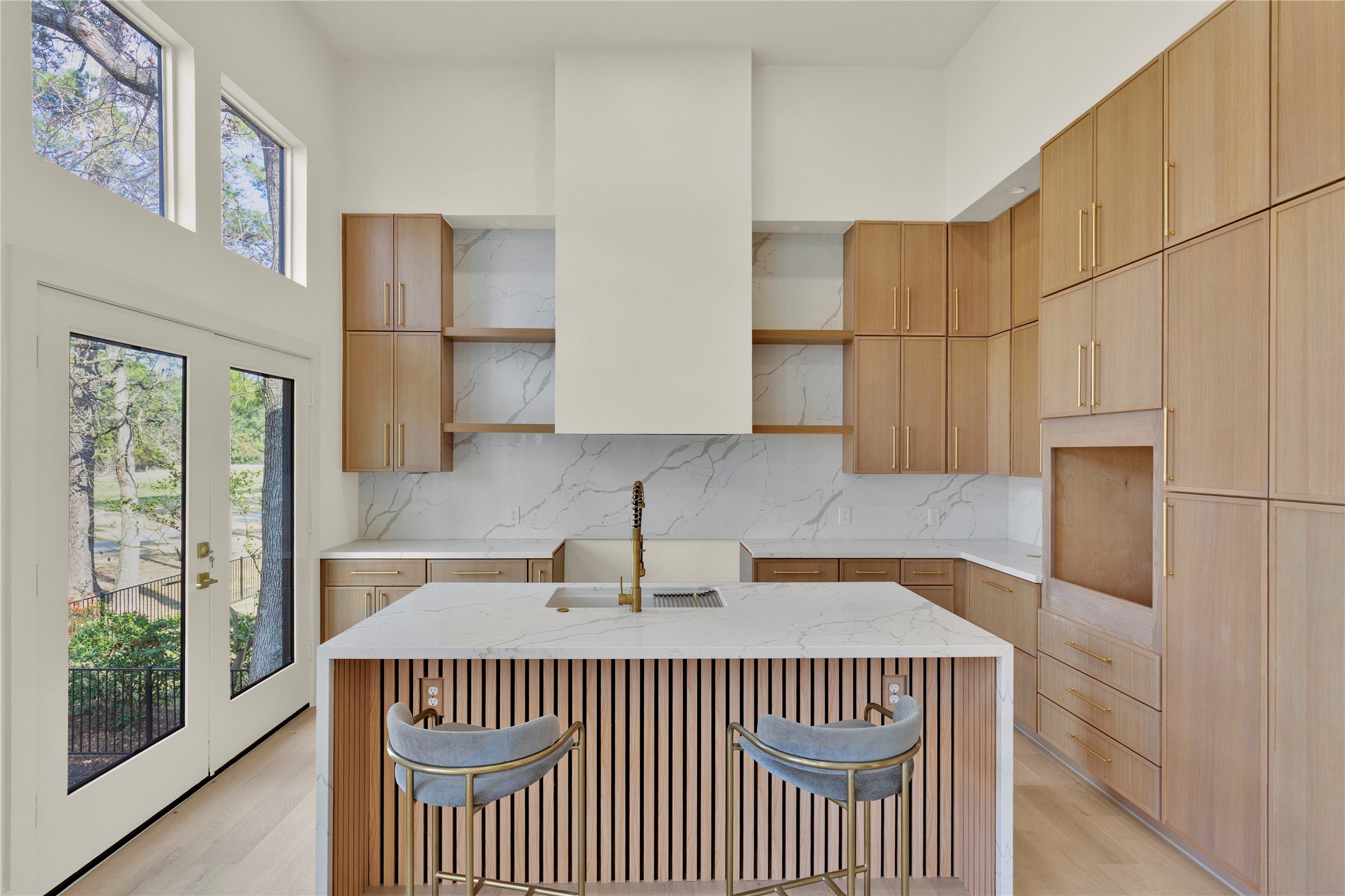 20 Buttonbush Court The Woodlands, TX 77380 - Photo 13 of 43 a kitchen with a sink a refrigerator and window