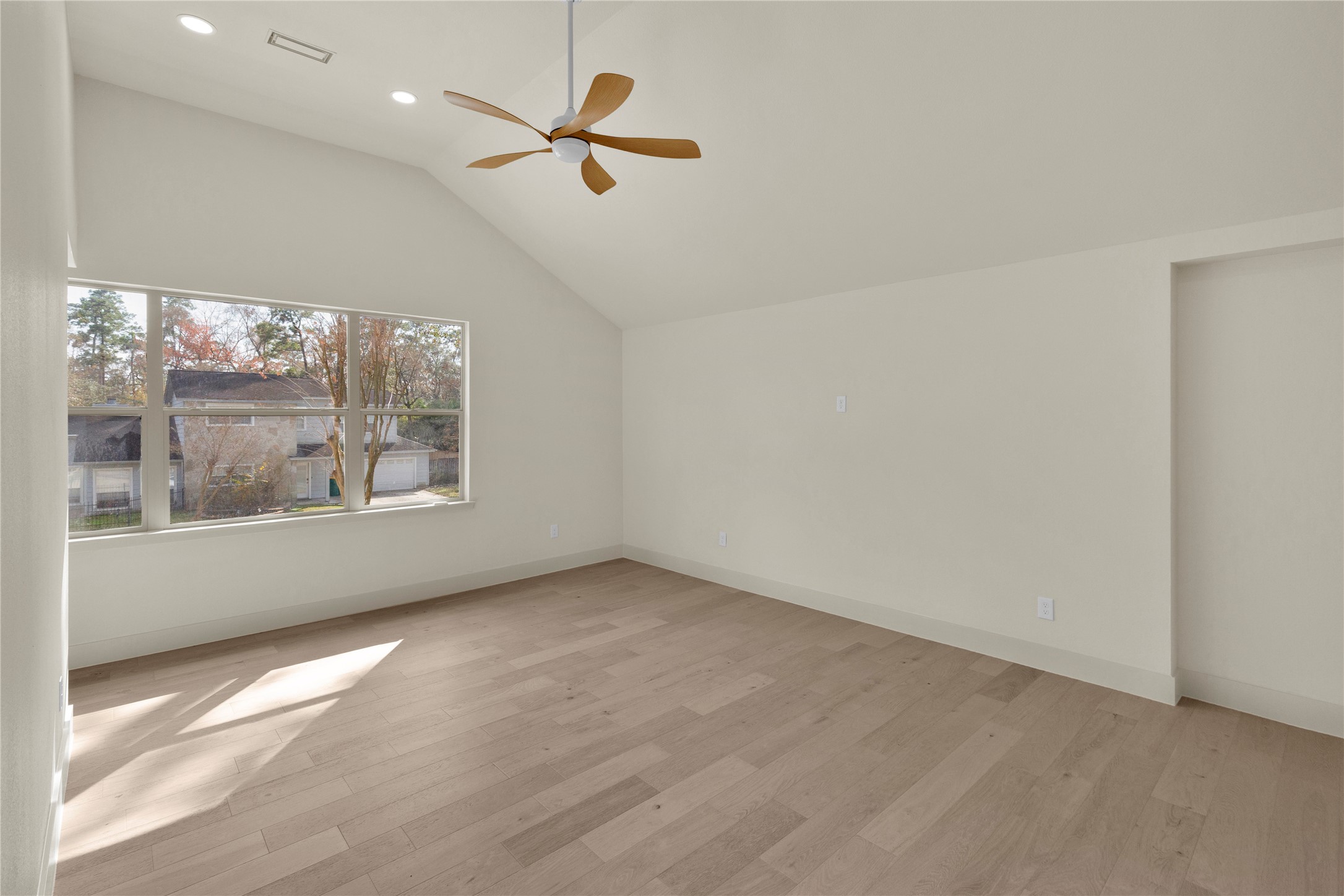 20 Buttonbush Court The Woodlands, TX 77380 - Photo 20 of 43 wooden floor in an empty room with a window