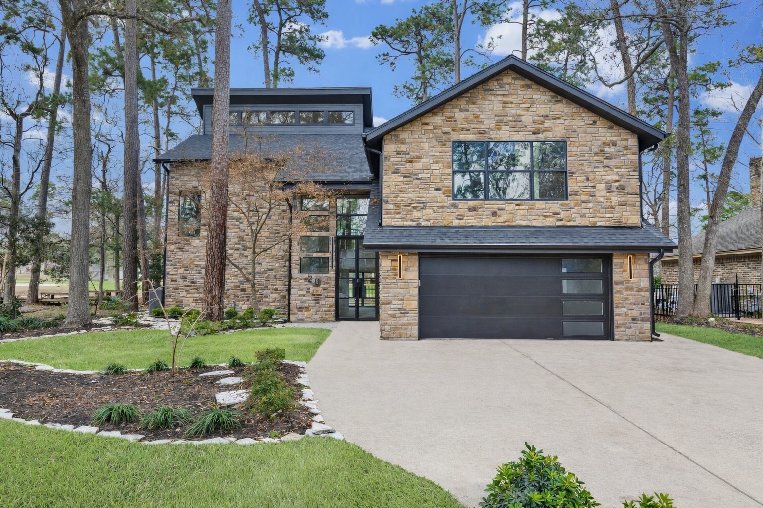 20 Buttonbush Court The Woodlands, TX 77380 - Photo 3 of 43 a view of a house with a yard and garage