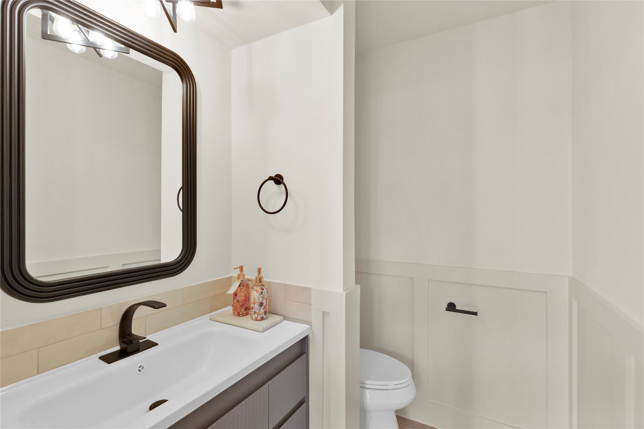 20 Buttonbush Court The Woodlands, TX 77380 - Photo 31 of 43 a bathroom with a sink a toilet and a mirror