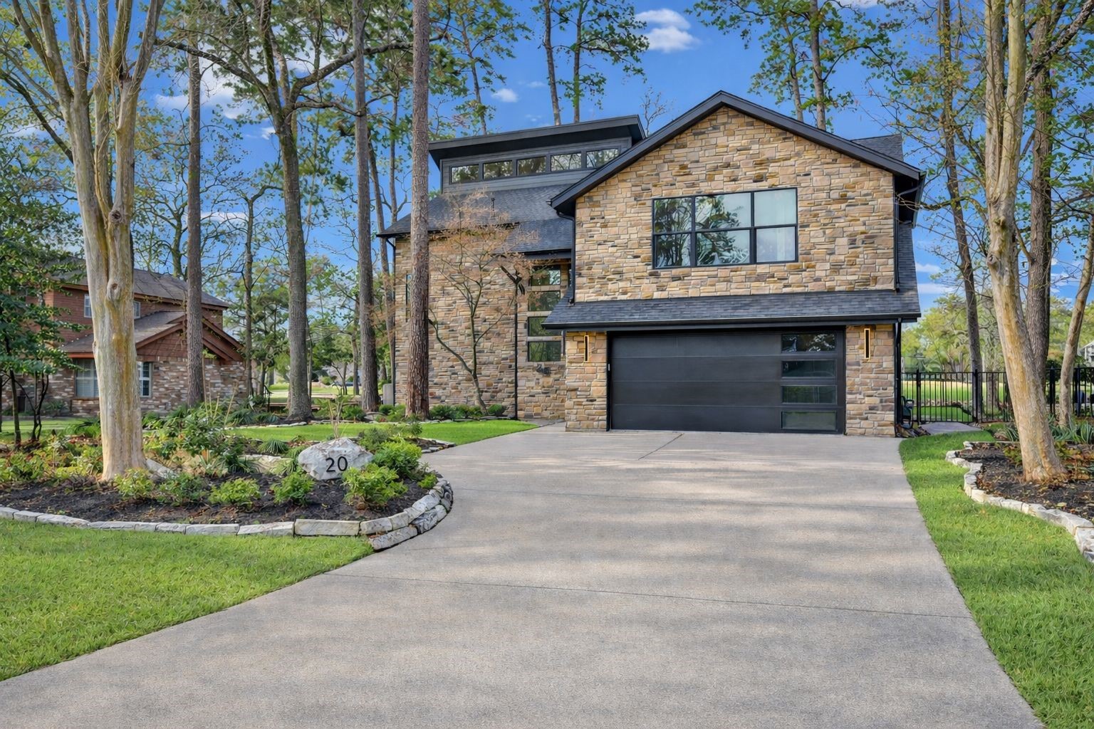 20 Buttonbush Court The Woodlands, TX 77380 - Photo 4 of 43 a front view of a house with a yard
