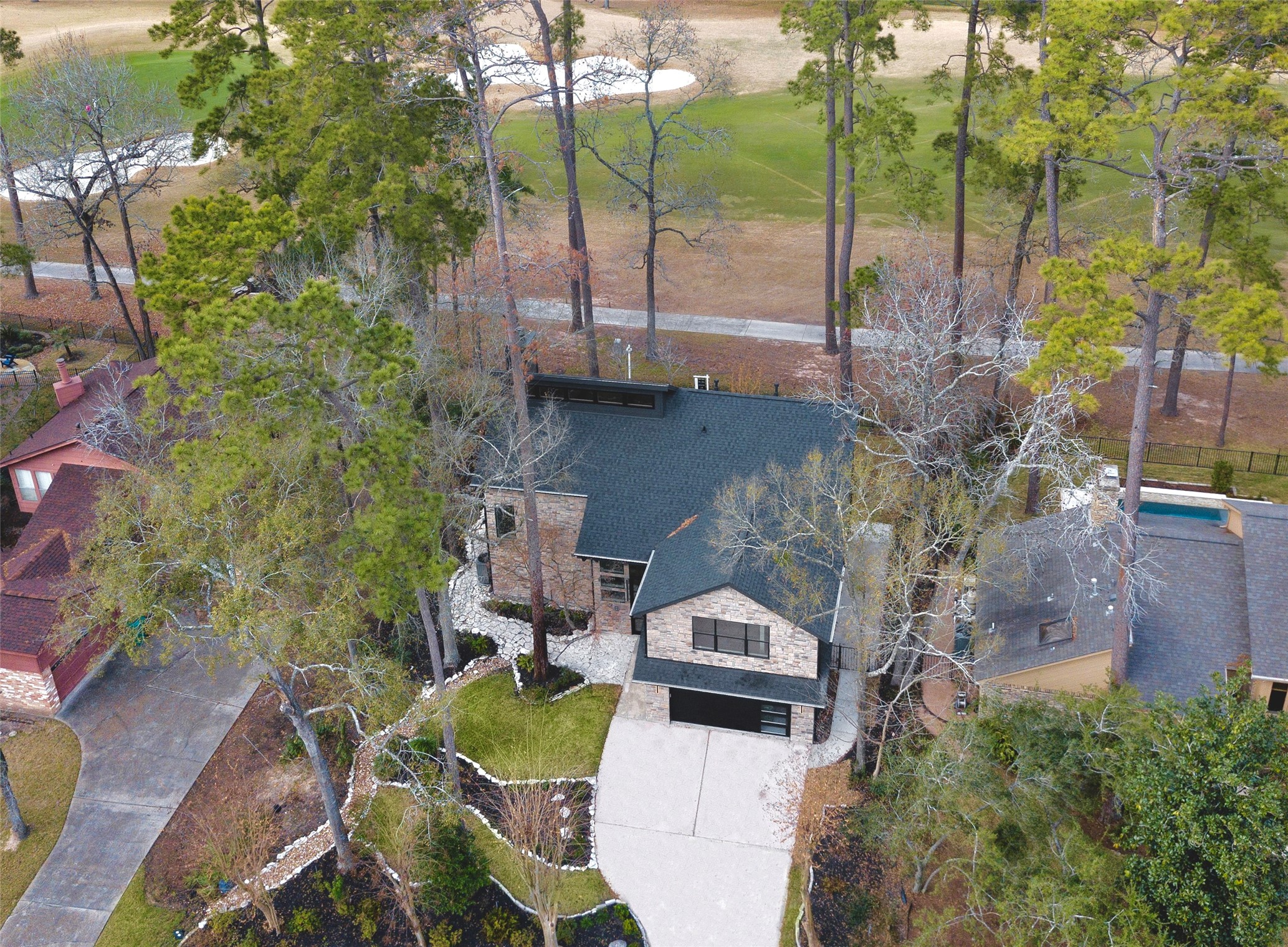 20 Buttonbush Court The Woodlands, TX 77380 - Photo 41 of 43 a aerial view of a house with a yard and lake view
