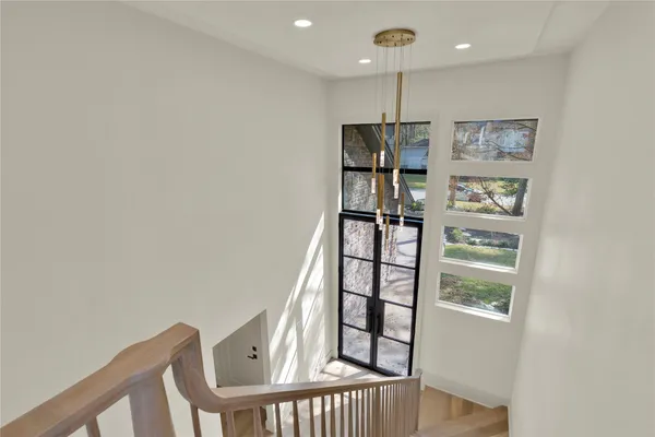 a living room with stainless steel appliances furniture and a large window