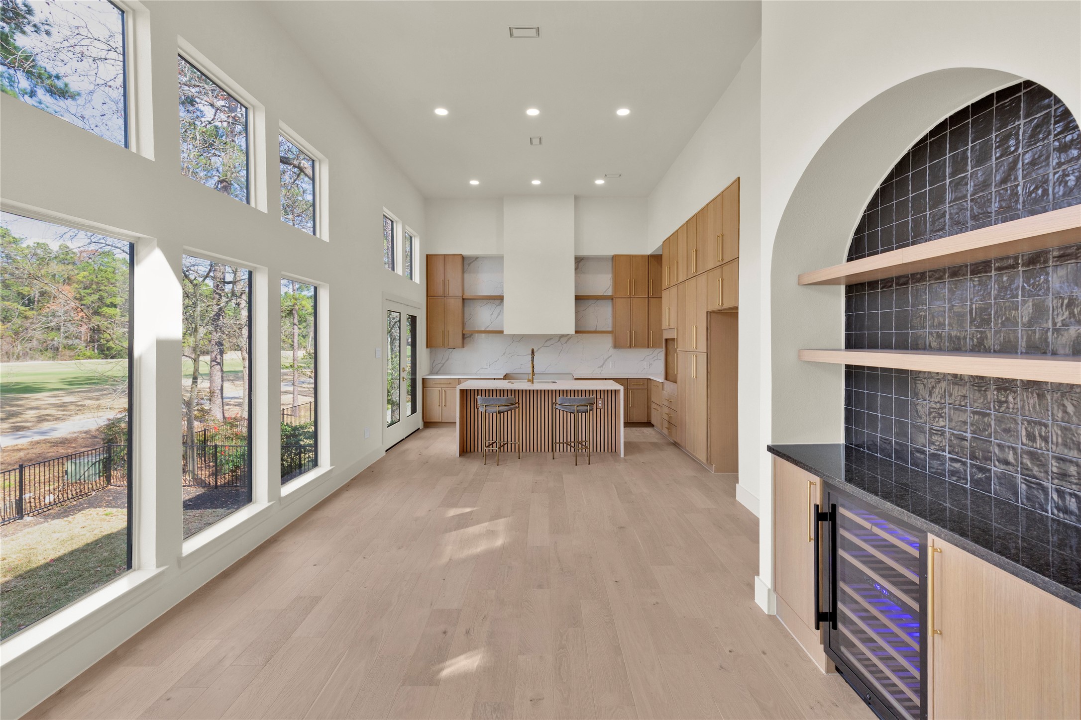 20 Buttonbush Court The Woodlands, TX 77380 - Photo 10 of 43 a living room with stainless steel appliances furniture and a large window