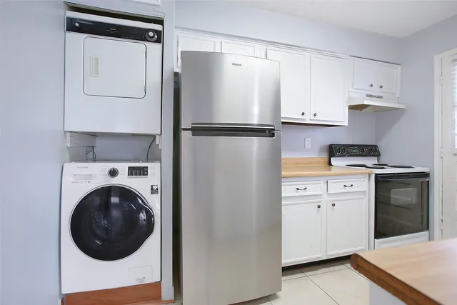 a kitchen with a refrigerator and washer