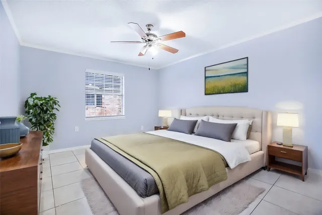 a bedroom with a bed and a potted plant