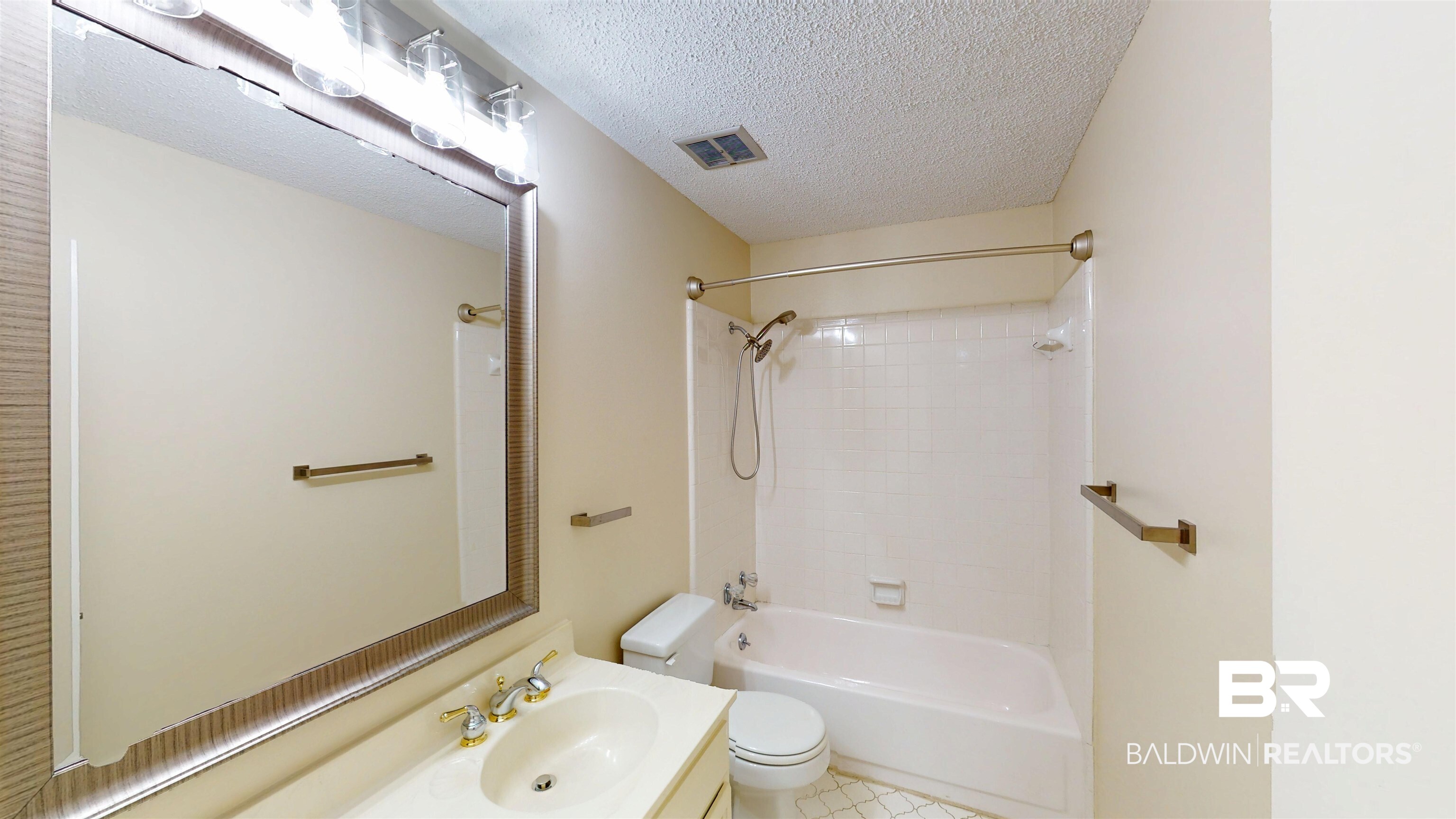 2901 Grant Street, Unit 902 Mobile, AL 36606 - Photo 13 of 35 Full bathroom with vanity, a textured ceiling, shower combination, and light tile patterned floors