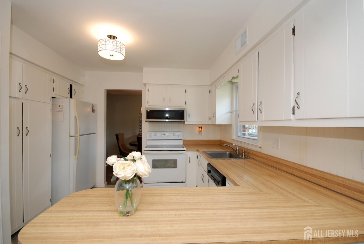 4 Kalman Court Middlesex, NJ 08846 - Photo 12 of 30 a kitchen with a refrigerator cabinets and wooden floor