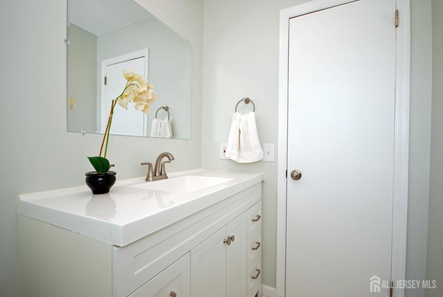 4 Kalman Court Middlesex, NJ 08846 - Photo 17 of 30 a bathroom with a sink and a mirror