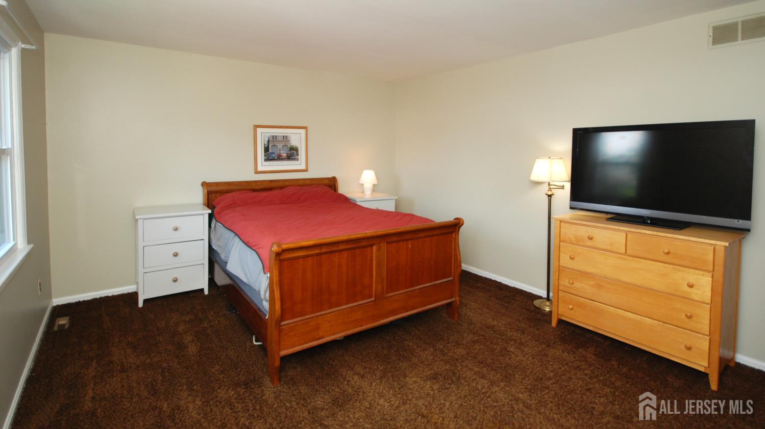 4 Kalman Court Middlesex, NJ 08846 - Photo 22 of 30 a bedroom with a bed and flat screen tv