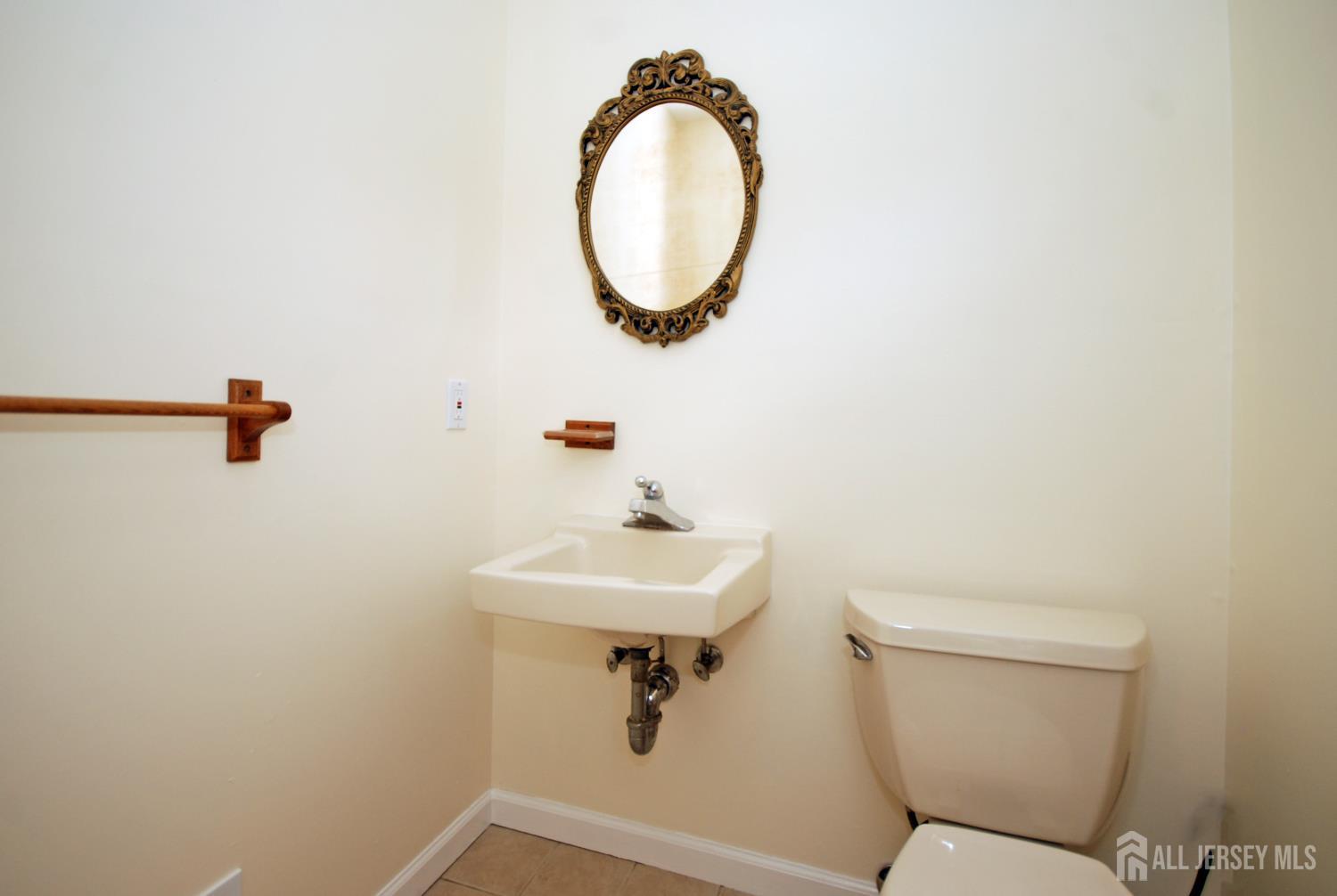 4 Kalman Court Middlesex, NJ 08846 - Photo 23 of 30 a bathroom with a toilet a sink and a mirror