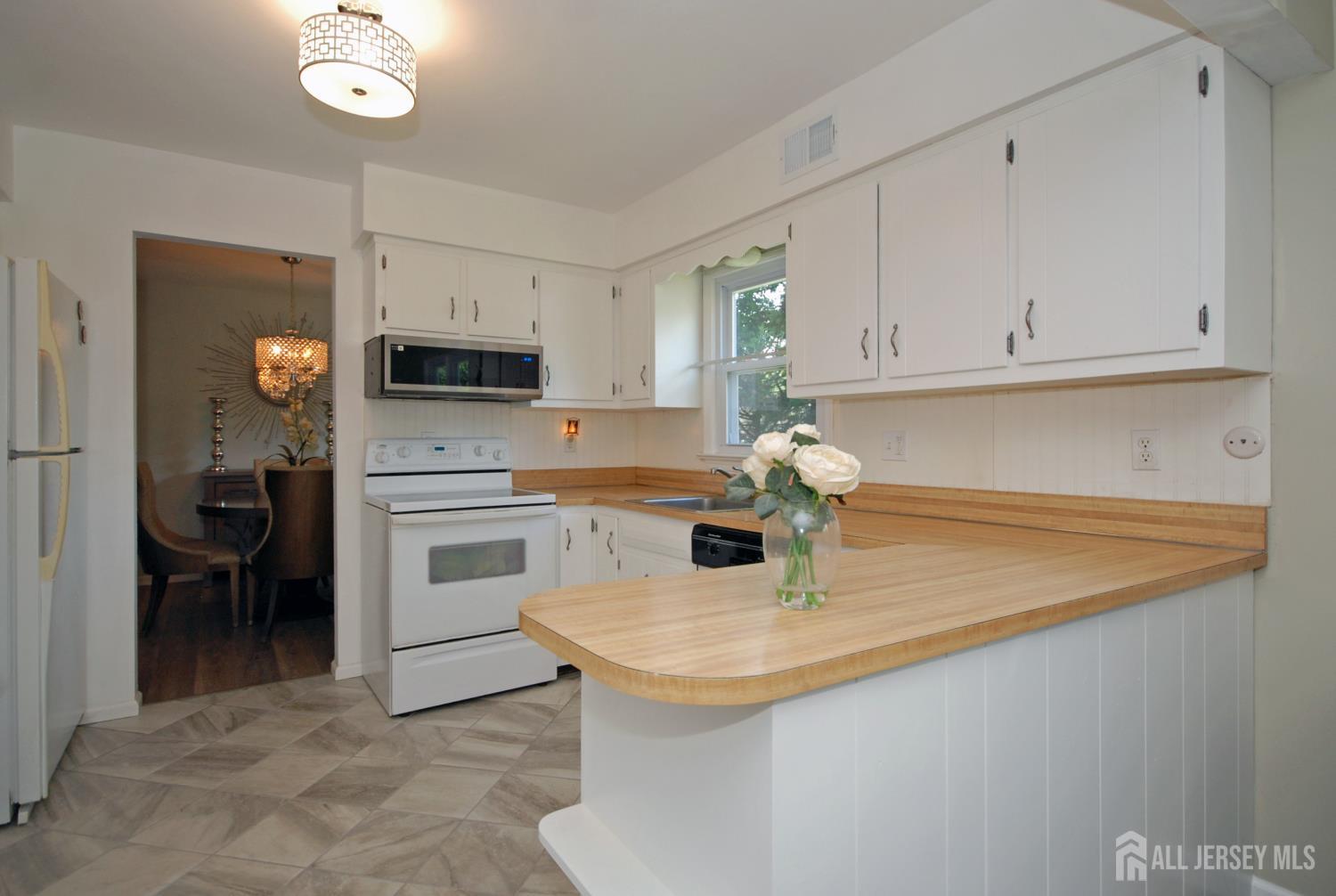 4 Kalman Court Middlesex, NJ 08846 - Photo 5 of 30 a kitchen with a sink a stove and cabinets