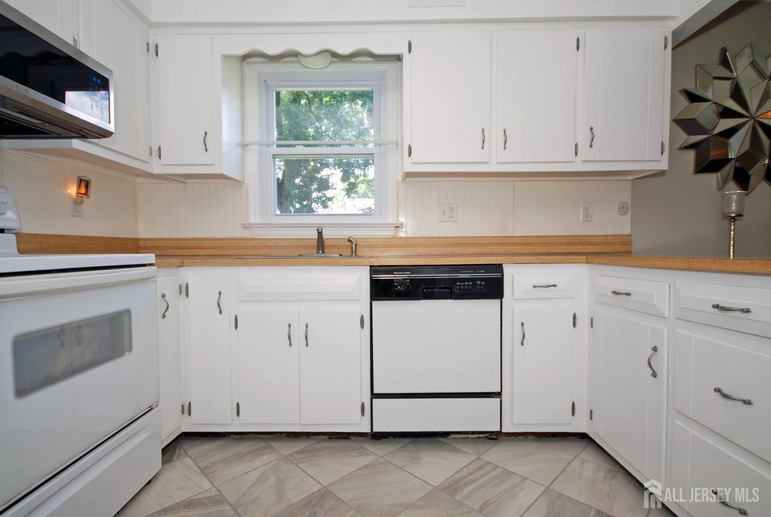 4 Kalman Court Middlesex, NJ 08846 - Photo 6 of 30 a kitchen with granite countertop white cabinets stainless steel appliances and a sink
