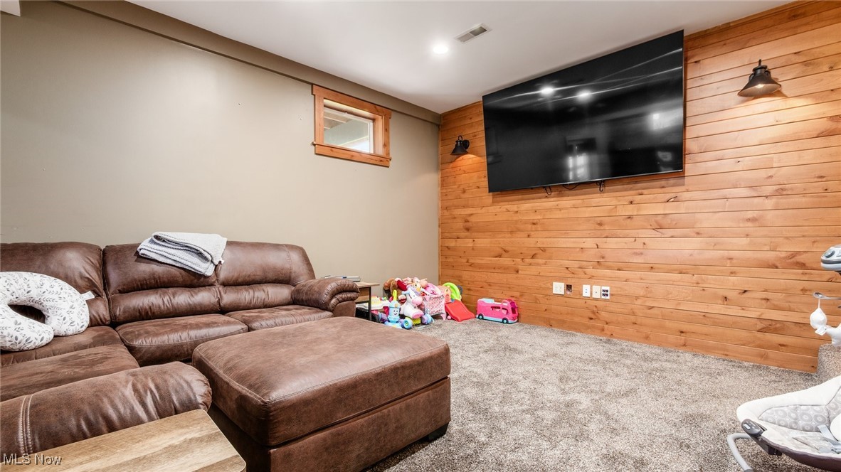 62960 James Road Cambridge, OH 43725 - Photo 31 of 40 Carpeted living area featuring wooden walls