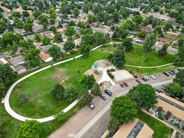 an aerial view of a house with a garden and deck