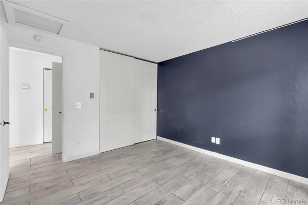 a view of empty room with wooden floor and fireplace