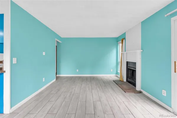 a kitchen with stainless steel appliances granite countertop a stove a refrigerator and a view of living room