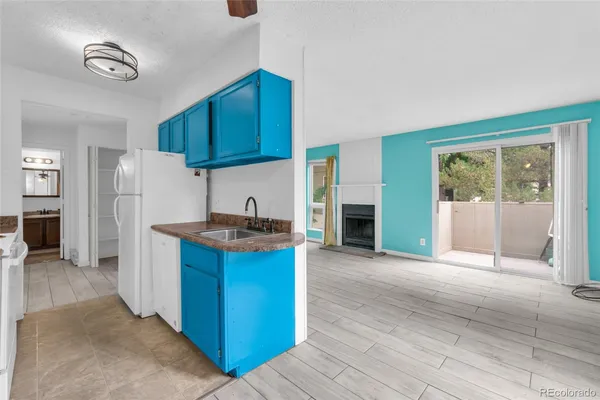 a kitchen with granite countertop a sink stove and cabinets