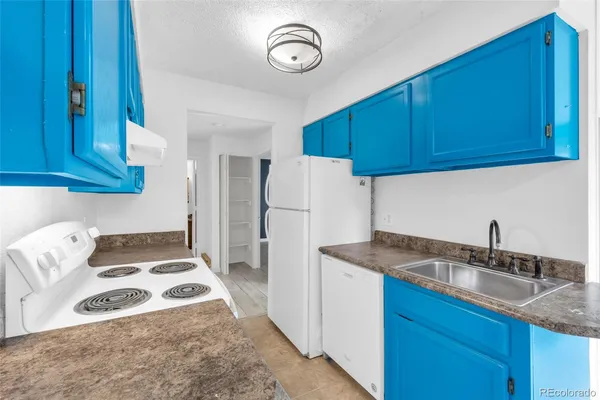 a kitchen with a sink cabinets and appliances