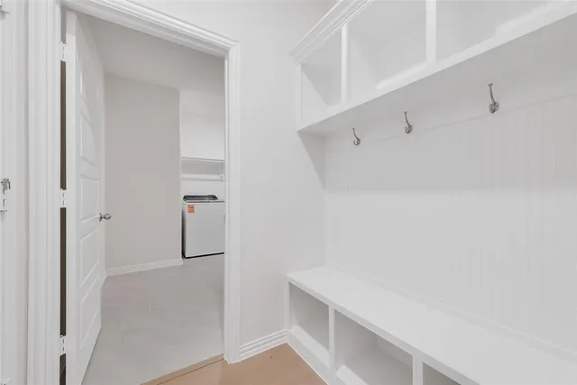 a room with white cabinets and a sink