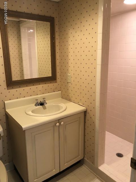2300 Upper River Road Macon, GA 31211 - Photo 25 of 32 a bathroom with a sink a mirror and a shower