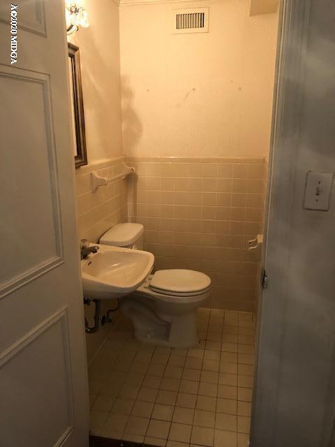 2300 Upper River Road Macon, GA 31211 - Photo 6 of 32 a bathroom with a toilet a sink and mirror