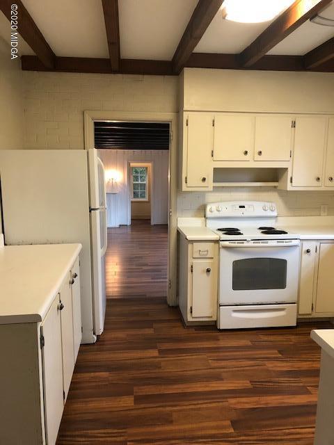 2300 Upper River Road Macon, GA 31211 - Photo 10 of 32 a kitchen with wooden floor and white appliances