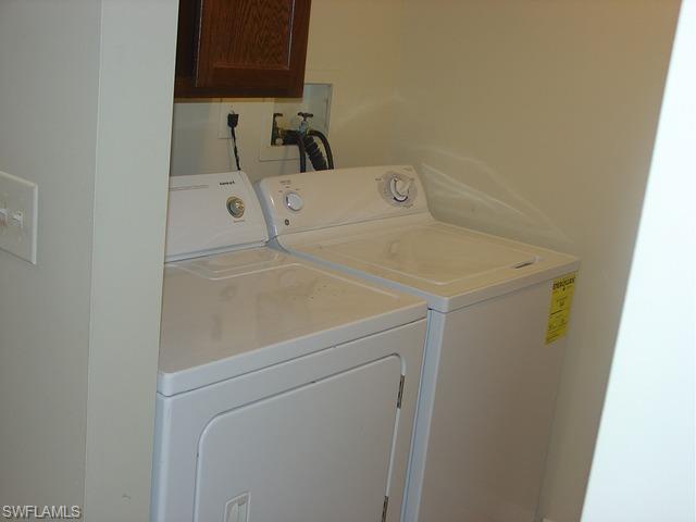 110 Cypress Way East, Unit F5 Naples, FL 34110 - Photo 11 of 11 a utility room with dryer and washer