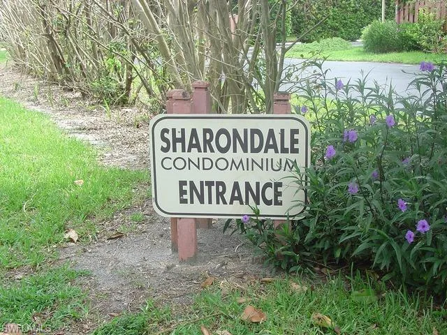 a sign that is sitting in front of flowers