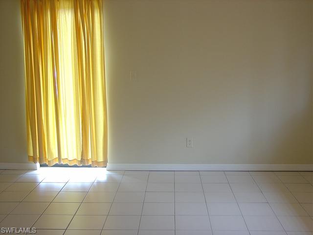 110 Cypress Way East, Unit F5 Naples, FL 34110 - Photo 7 of 11 a view of an empty room and window