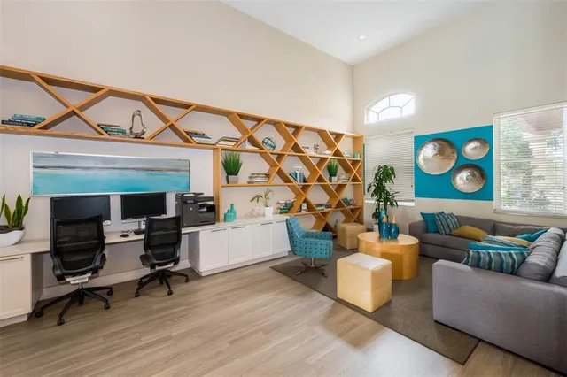 a living room with patio furniture and a wooden floor