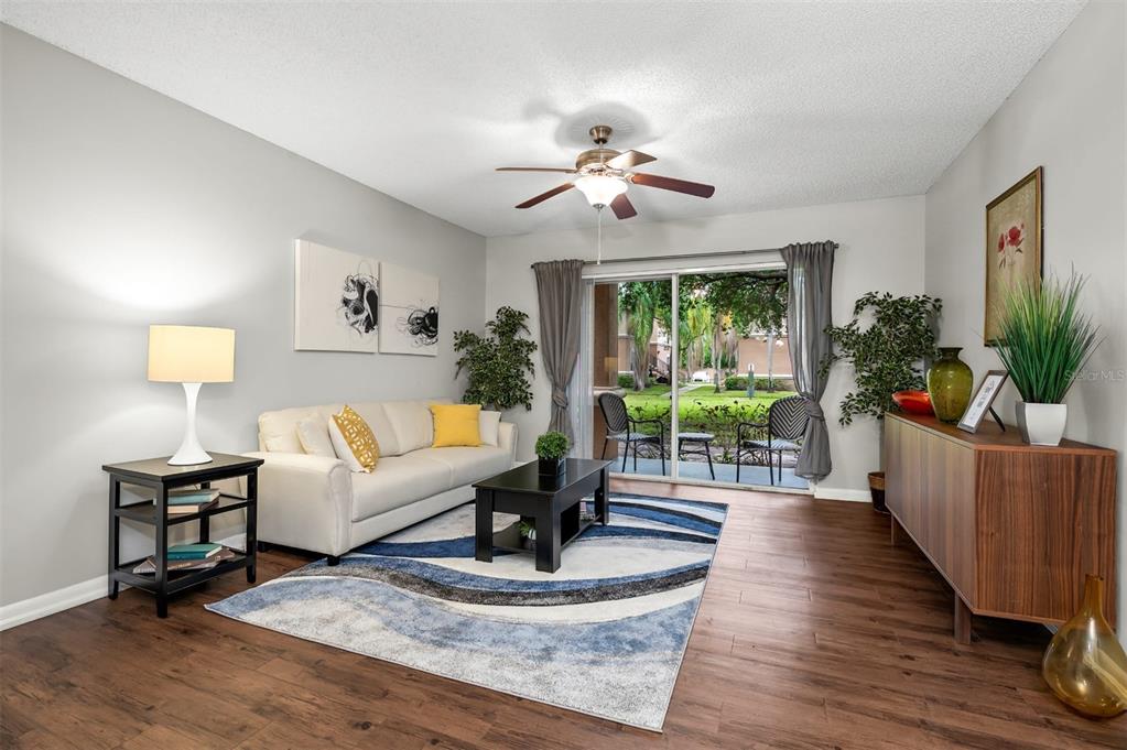 10101 Southwest 14th Street, Unit 2B9202 Pembroke Pines, FL 33025 - Photo 14 of 48 a living room with furniture and a large window