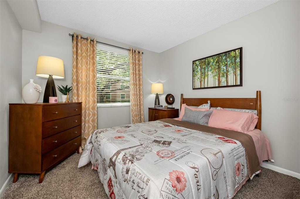 10101 Southwest 14th Street, Unit 2B9202 Pembroke Pines, FL 33025 - Photo 21 of 48 a bedroom with a bed and a lamp on dresser