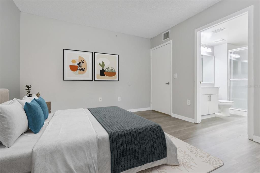 10101 Southwest 14th Street, Unit 2B9202 Pembroke Pines, FL 33025 - Photo 25 of 48 a bedroom with a bed and wall painting