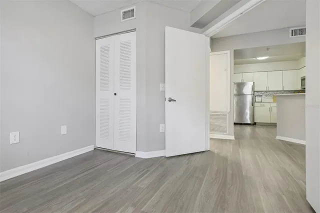 a view of a kitchen with a white cabinets and wooden floor