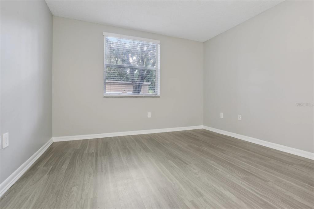 10101 Southwest 14th Street, Unit 2B9202 Pembroke Pines, FL 33025 - Photo 48 of 48 an empty room with wooden floor and windows