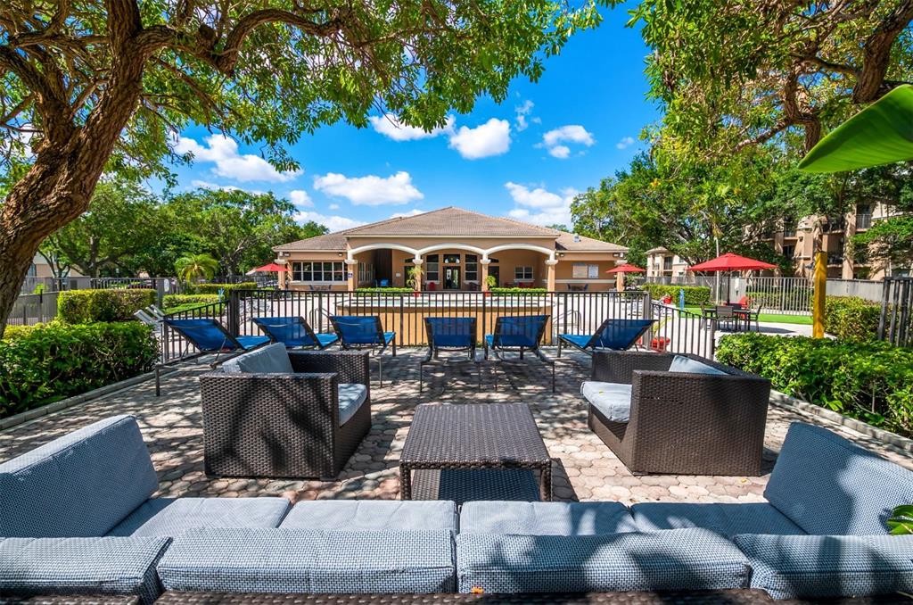 10101 Southwest 14th Street, Unit 2B9202 Pembroke Pines, FL 33025 - Photo 7 of 48 a front view of house with yard outdoor seating and green space