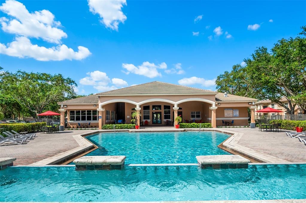 10101 Southwest 14th Street, Unit 2B9202 Pembroke Pines, FL 33025 - Photo 10 of 48 a front view of a house with a yard table and chairs