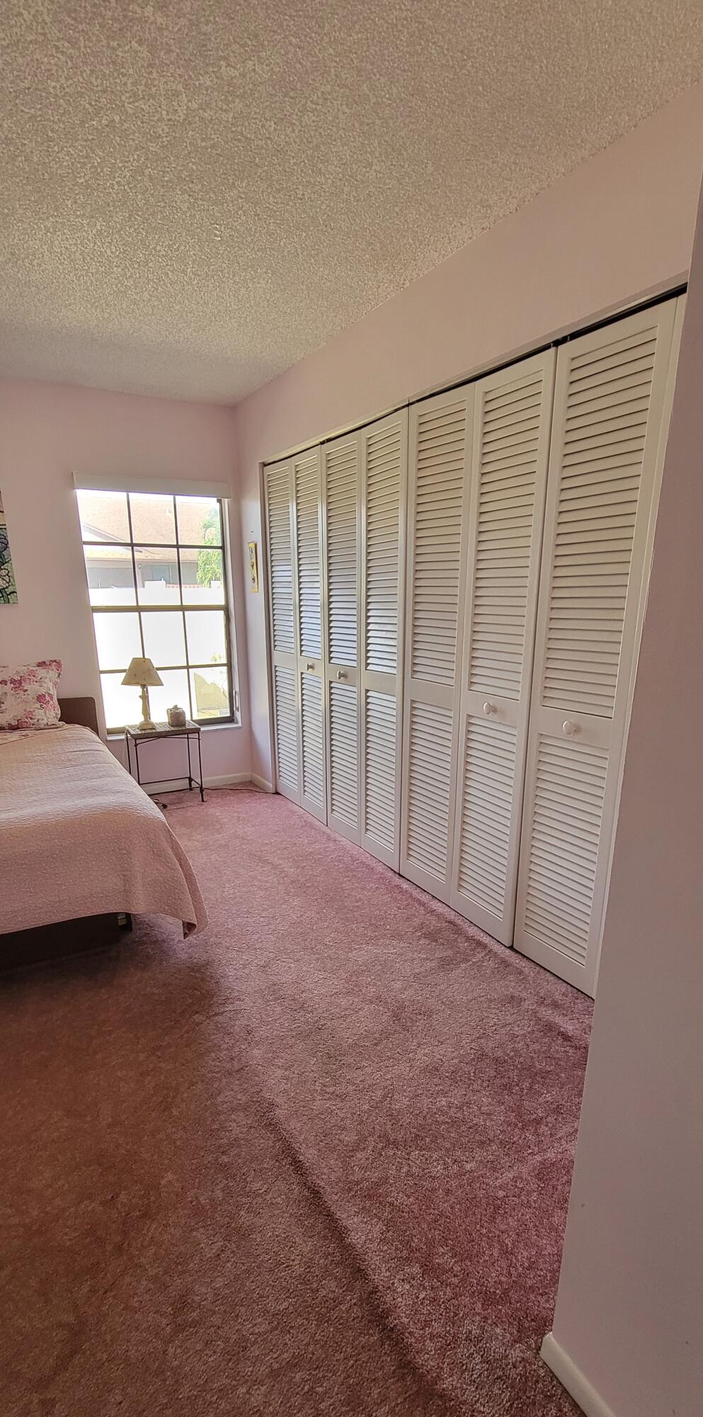 493 Southwest 28th Avenue Delray Beach, FL 33445 - Photo 20 of 48 a view of a bedroom with a bed and a window