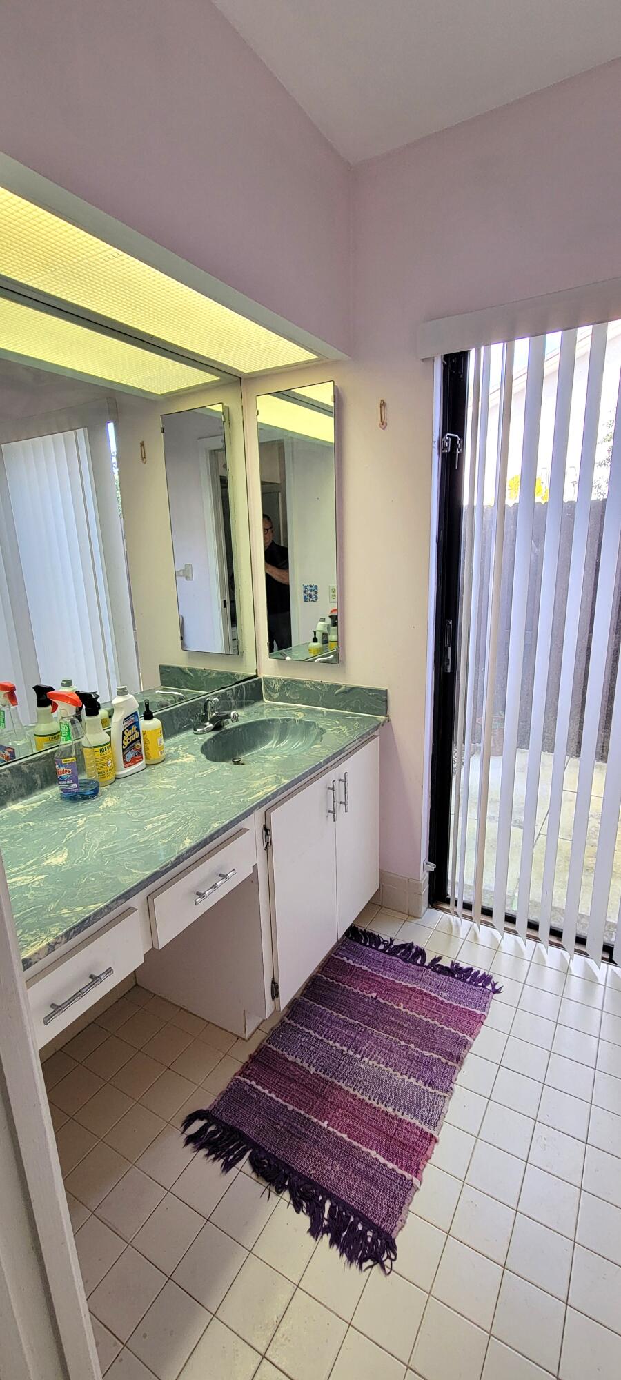 493 Southwest 28th Avenue Delray Beach, FL 33445 - Photo 24 of 48 a spacious bathroom with a granite countertop sink and a window