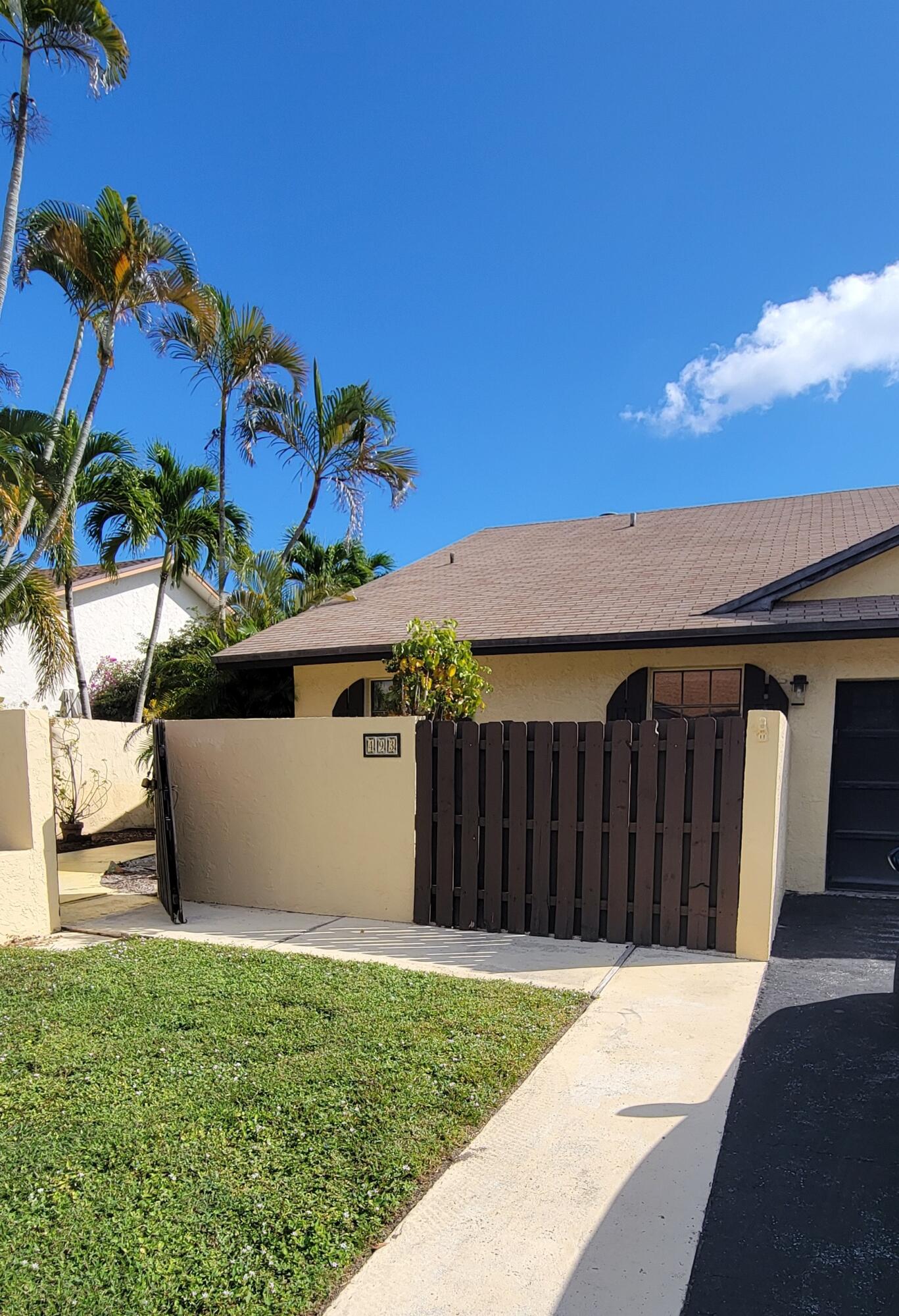 493 Southwest 28th Avenue Delray Beach, FL 33445 - Photo 3 of 48 a view of a house with a backyard
