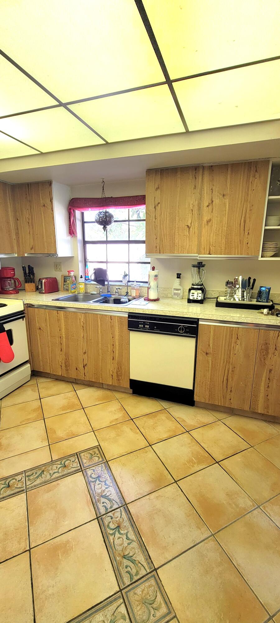 493 Southwest 28th Avenue Delray Beach, FL 33445 - Photo 32 of 48 a view of a kitchen with a sink and cabinets
