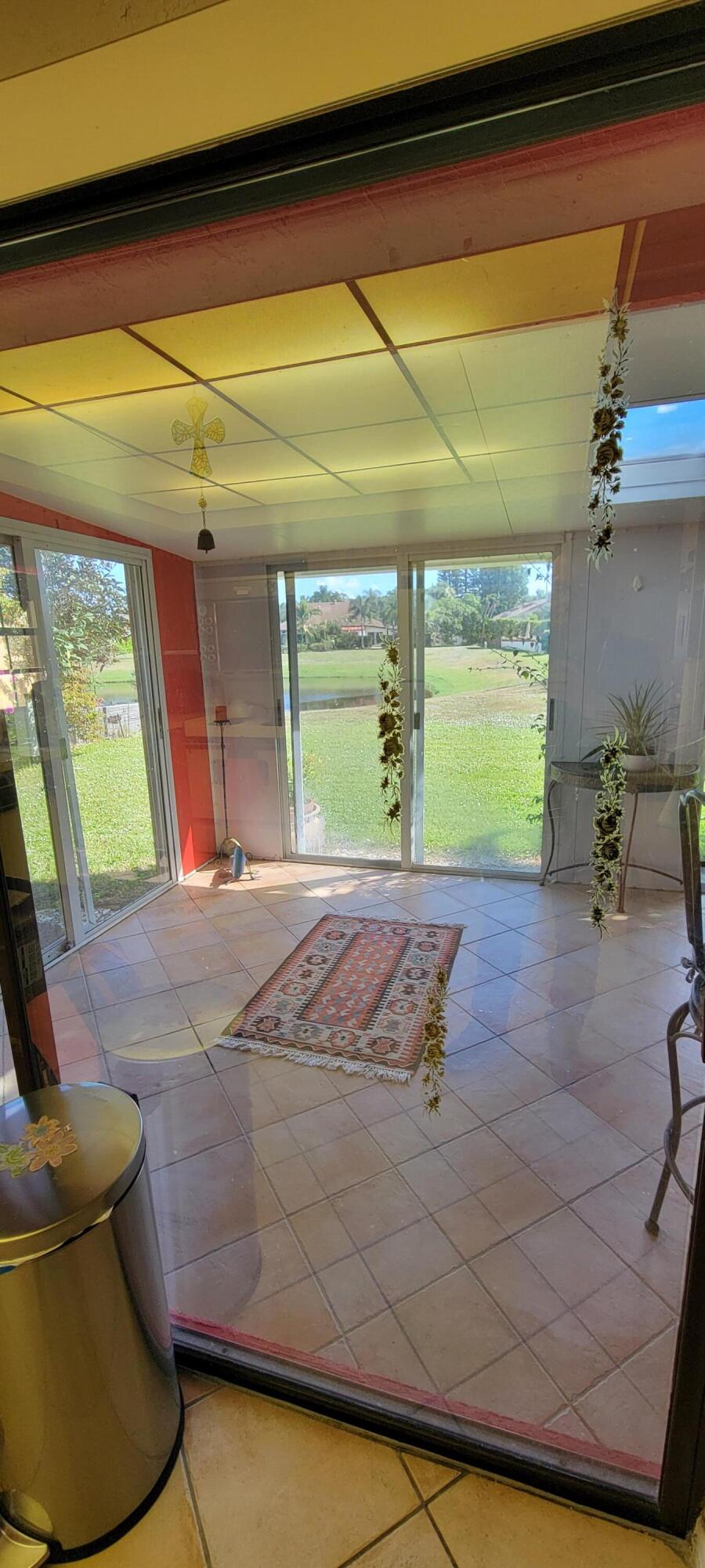 493 Southwest 28th Avenue Delray Beach, FL 33445 - Photo 33 of 48 a view of a room with wooden floor and a potted plant