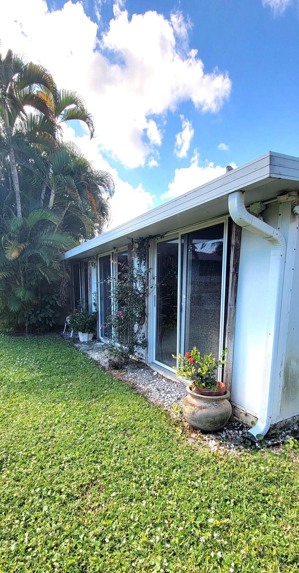 493 Southwest 28th Avenue Delray Beach, FL 33445 - Photo 40 of 48 a front view of a house with a yard
