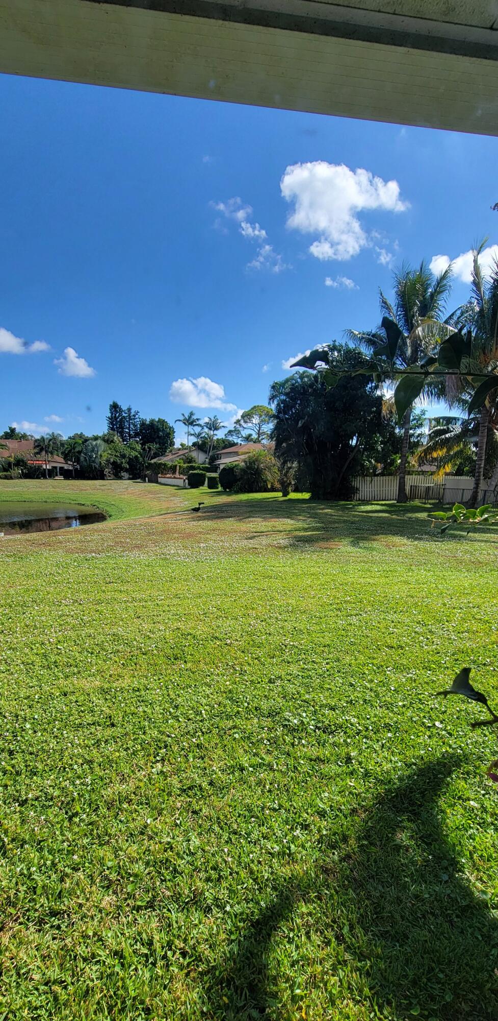 493 Southwest 28th Avenue Delray Beach, FL 33445 - Photo 43 of 48 a view of a lake with houses in the back
